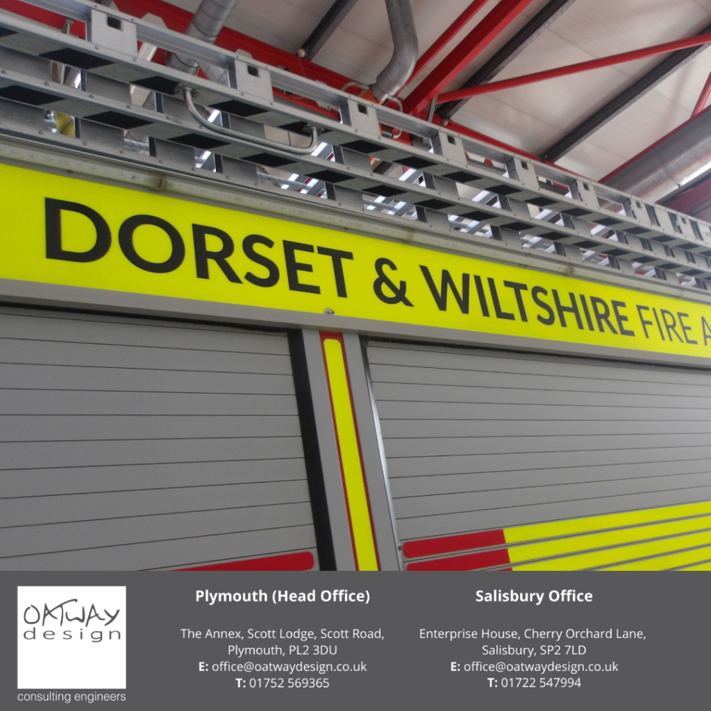 Close-up of Dorset & Wiltshire Fire and Rescue Service signage inside Westlea Fire Station, designed by Oatway Design Ltd – Building Services Engineering consultants.
